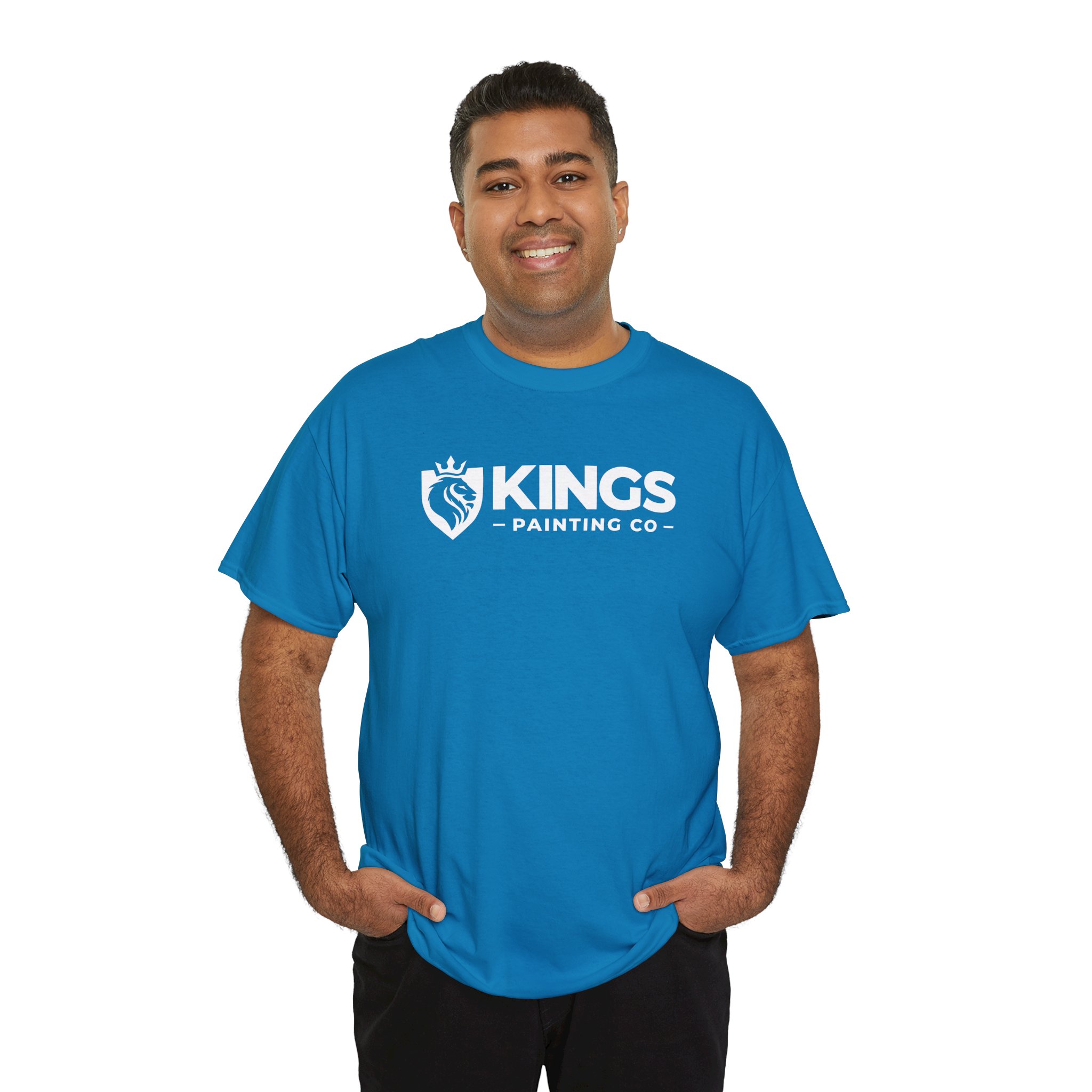 Smiling person wearing a Kings Painting Co. Logo T‑Shirt (Classic) | Gildan Ultra Cotton (G5000) in blue, with hands in pockets, standing against a plain white background.