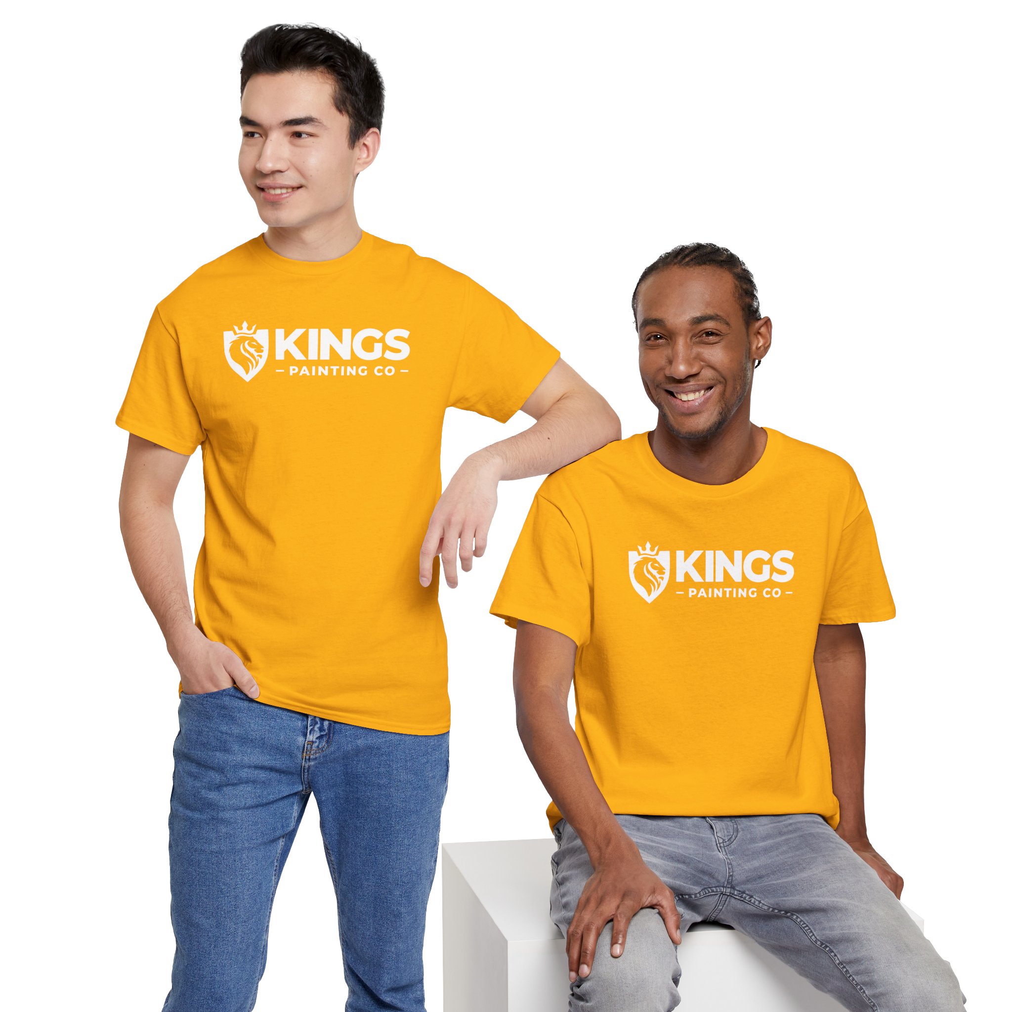 Two men smile while showcasing the Kings Painting Co. Logo T‑Shirt (Classic) | Gildan Ultra Cotton (G5000) in bright yellow; one stands with a hand in his pocket, and the other sits on a white block, both set against a plain white background.